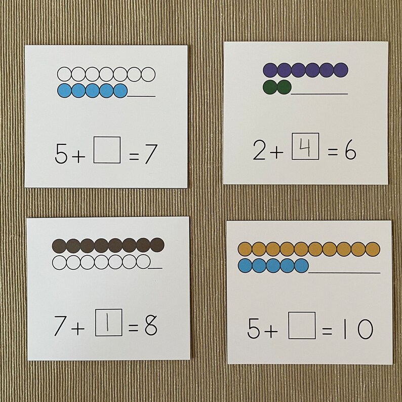 May include: Four cards with addition problems and colorful beads representing the numbers. The first card shows 5 blue beads and 2 white beads with the equation 5 + 2 = 7. The second card shows 2 green beads and 4 purple beads with the equation 2 + 4 = 6. The third card shows 7 brown beads and 1 white bead with the equation 7 + 1 = 8. The fourth card shows 5 blue beads and 5 gold beads with the equation 5 + 5 = 10.
