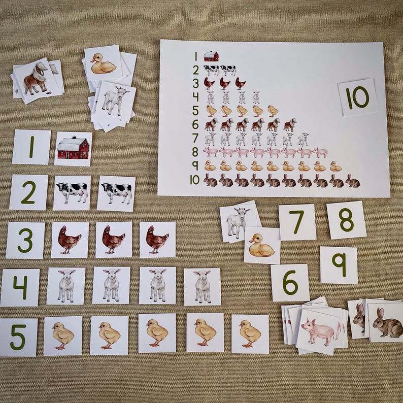 May include: A set of colorful farm animal flashcards with numbers 1 through 10. The cards feature images of a barn, cow, chicken, duck, goat, pig, and rabbit. The cards are arranged in a pyramid shape on a white background.