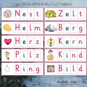 May include: A set of 10 colourful flashcards with illustrations and German words. The words are: Nest, Zelt, Helm, Berg, Herz, Kern, Pilz, Kind, Ring, Bild.