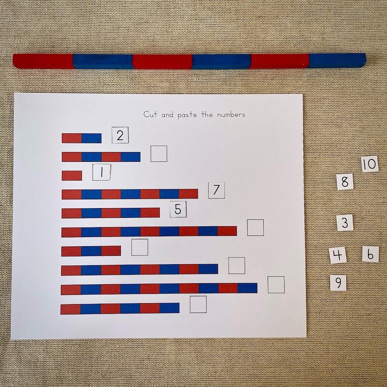 May include: A worksheet with a red and blue striped bar at the top. The worksheet has a title that says "Cut and paste the numbers". There are 7 rows of red and blue blocks with numbers 1, 2, 5, and 7 written next to them. There are blank spaces for the numbers 3, 4, 6, 8, 9, and 10 to be pasted in. The numbers 3, 4, 6, 8, 9, and 10 are cut out and placed to the right of the worksheet.