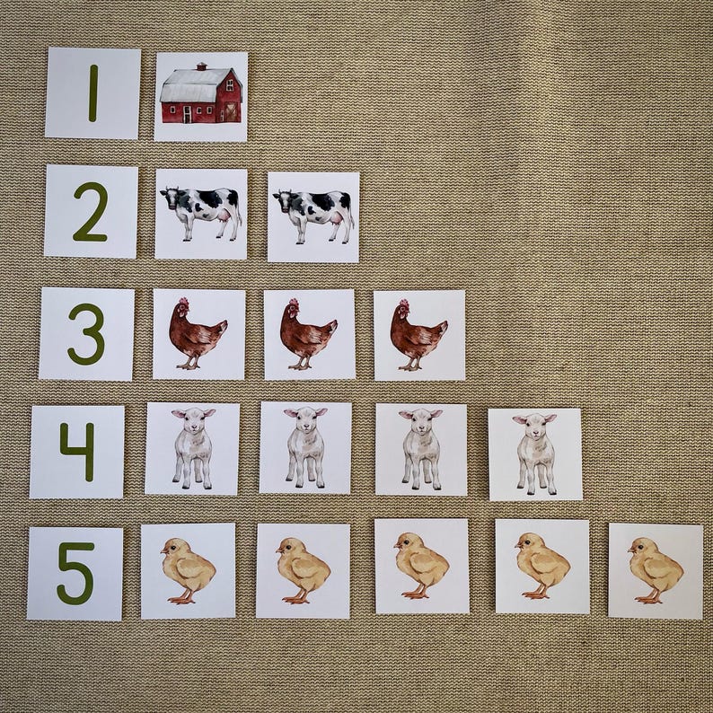 May include: A set of five cards with numbers 1 through 5 printed in green. Each card has a corresponding number of farm animals: a red barn, two cows, three chickens, four lambs, and five chicks.