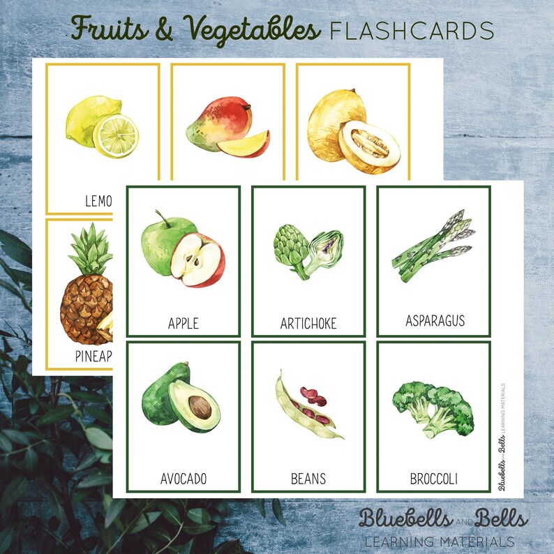 May include: A set of colorful flashcards featuring illustrations of fruits and vegetables. The flashcards are labeled with the name of each fruit or vegetable, such as lemon, apple, artichoke, asparagus, pineapple, avocado, beans, and broccoli.