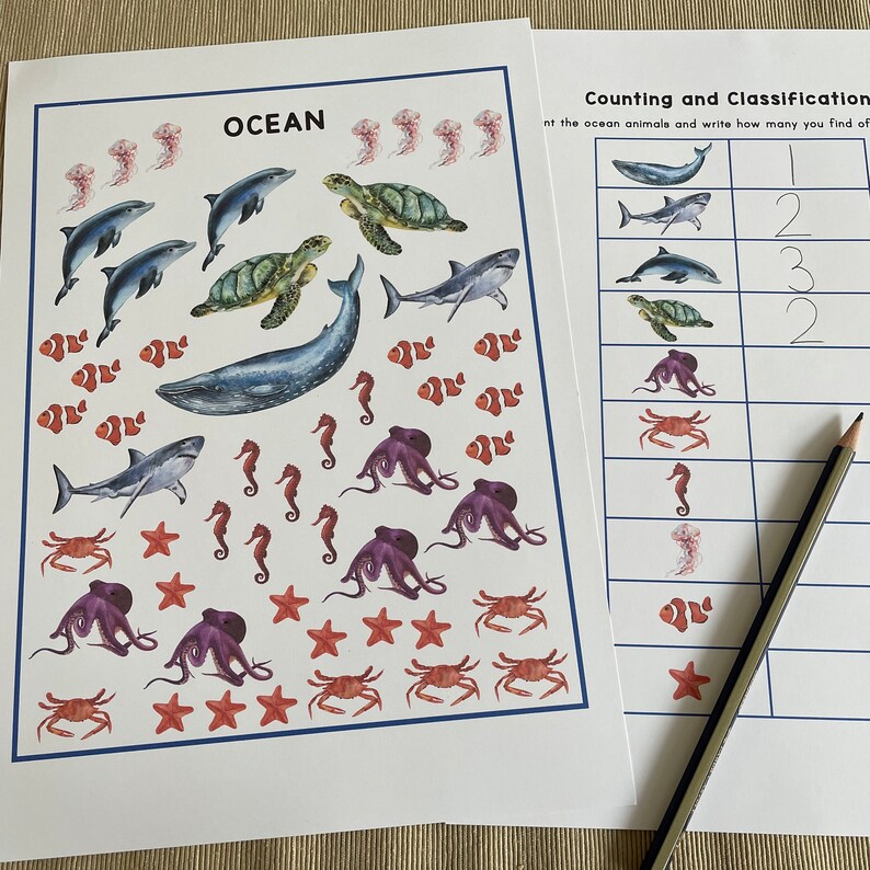 May include: A printable worksheet for kids to count and classify ocean animals. The worksheet features colorful illustrations of sea creatures like jellyfish, dolphins, sea turtles, sharks, clownfish, seahorses, octopuses, starfish, and crabs. The worksheet includes a table for kids to write the number of each animal they find.