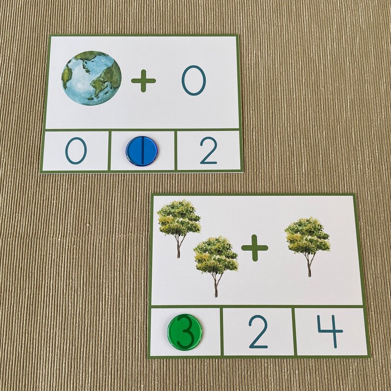 May include: Two math flash cards with a green and blue background. The first card shows a picture of the Earth and the equation 0 + 0 = 2. The second card shows a picture of three trees and the equation 3 + 2 = 4.