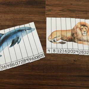 May include: Two printable educational activity sheets for kids. One sheet features a blue dolphin with numbers 12 to 120 printed below. The other sheet features a brown lion with numbers 4 to 40 printed below.