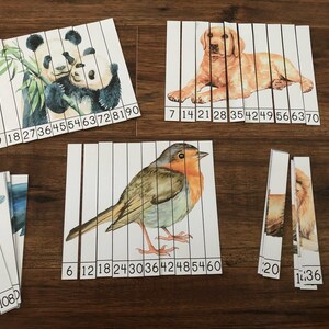 May include: A set of 10 printable puzzle strips featuring watercolor illustrations of animals. The animals include a panda, a dog, a robin, and a lion. Each strip has numbers printed on it, indicating the order in which the strips should be assembled.
