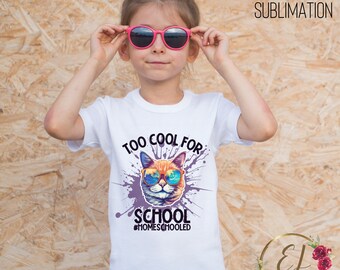 May include: White t-shirt with a colorful graphic of a cat wearing sunglasses and the text "Too Cool For School #HOMESCHOOLED"