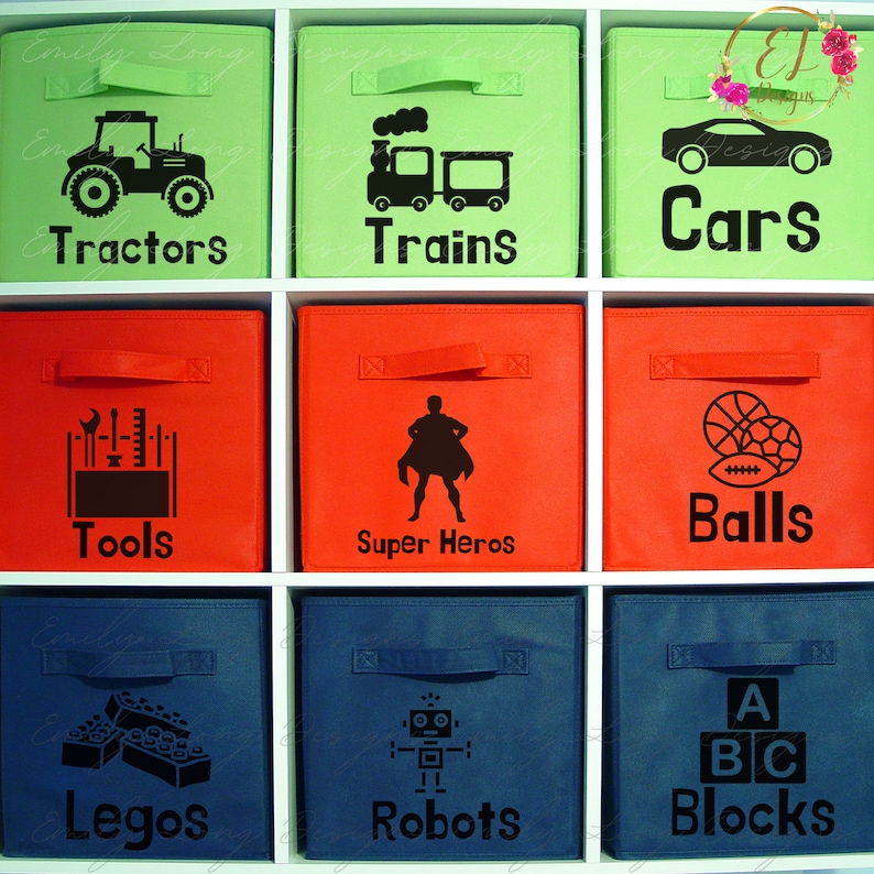 May include: Nine fabric storage bins with black labels and icons. The labels read: Tractors, Trains, Cars, Tools, Super Heros, Balls, Legos, Robots, and Blocks. The icons depict a tractor, train, car, tools, superhero, basketball and football, lego blocks, robot, and alphabet blocks.