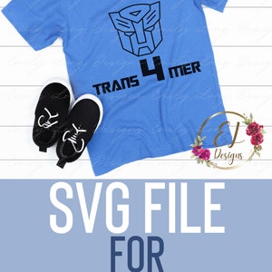 May include: A blue t-shirt with a black Transformers logo and the text "TRANS 4 MER" on it. The shirt is on a white wooden surface with a pair of black shoes.