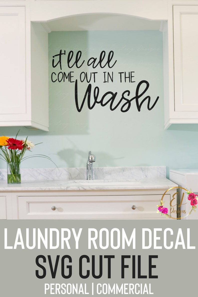 May include: A white laundry room with a white cabinet and a white sink. The wall is light blue and has a black vinyl decal that says "it'll all come out in the wash".