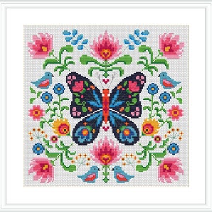 May include: Cross-stitch design featuring a central butterfly with intricate patterns in blue, pink, and orange. The butterfly is surrounded by floral and bird motifs in a square frame, all on a white background. The design is framed in a white border.