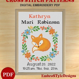 May include: Cross stitch pattern featuring a sleeping fox surrounded by a floral wreath. The pattern includes the name "Kathryn Mari Robinson" and the birth details "August 20, 2022, 10:25 am, 7 lbs, 8 oz, 20 in."