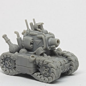 May include: A grey, detailed, plastic model of a tank with a large cannon and multiple smaller guns. The tank has a textured surface and a detailed design.