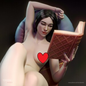 May include: A woman with long black hair is lying on a bed, reading a book. She is wearing a blue pillow and a red heart is covering her chest.