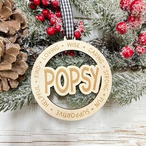 May include: Wooden Christmas ornament with the name "POPSY" in the center and the words "kind, loving, wise, caring, strong, fun, helpful, supportive" around the edge.