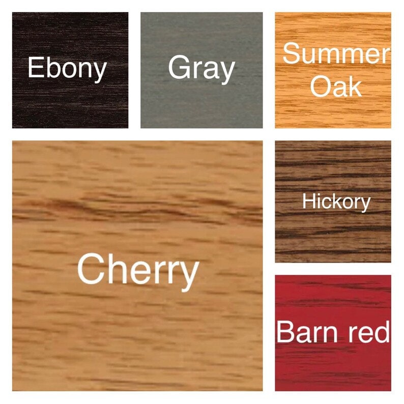 May include: A color palette chart displaying six wood stain samples with labels: Ebony, Gray, Summer Oak, Cherry, Hickory, and Barn red. Each square shows a distinct wood grain texture and color, ranging from dark black to light tan and red.