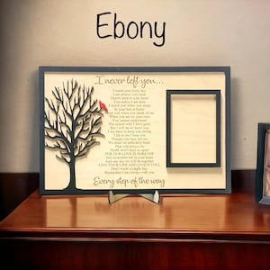 May include: A rectangular wooden memorial plaque with a dark frame, featuring a laser-cut black tree with a small red bird, a rectangular photo frame, and the text: I never left you... I watch you every day... Every step of the way.