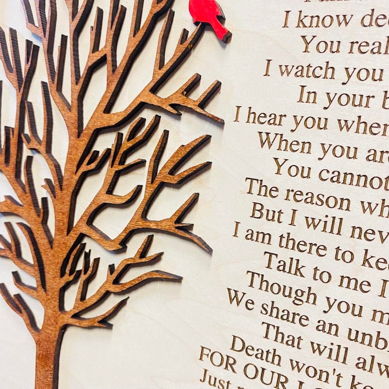 May include: A light-colored wooden plaque featuring a laser-cut dark brown tree silhouette on the left side with a small red bird perched on a branch. The right side displays engraved black text that reads I know deep down you really miss me.