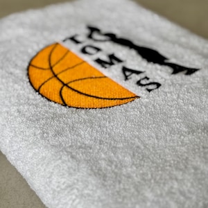 May include: White towel with black embroidery of a basketball and the text "I love basketball".