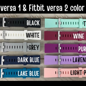 May include: Color chart for Fitbit Versa 1 & 2 watch bands. The image displays various colored bands, including black, white, grey, dark blue, lake blue, teal, wine red, purple, lavender, and light pink. Each band has a silver buckle.