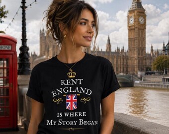May include: A black t-shirt featuring a gold crown icon above the white text 'KENT ENGLAND IS WHERE MY STORY BEGAN' and a graphic of the Union Jack flag. The design is centered on the chest of the shirt, which is worn in an outdoor setting.