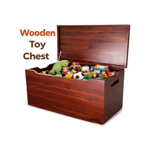 May include: A rectangular dark brown wooden toy chest with an open lid and side handles. The chest is filled with various colorful plastic toys, including a green dinosaur figure and a black and white soccer ball. The text Wooden Toy Chest is visible.