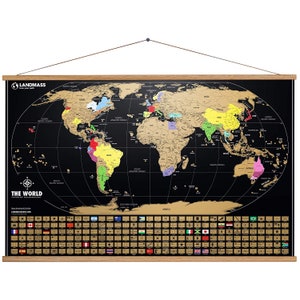 May include: A black world map with gold foil detailing, featuring country outlines and flags. The map is suspended by a wooden frame and includes the text "LANDMASS" and "THE WORLD".