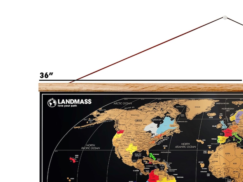 May include: A black world map with gold foil detailing, measuring 36 inches wide. The map features the text "LANDMASS love your path" and includes labels for oceans and continents. The map is mounted on a wooden frame.