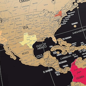 May include: A detailed map of North and South America, with a black background and gold-colored landmasses. The USA, Mexico, and Colombia are highlighted in yellow and red. The map includes country names and geographical features.