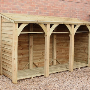 May include: A wooden log storage shed with a slanted roof and three open compartments. The shed is made of natural wood and has a rustic appearance.