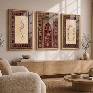May include: Three framed art prints with Islamic calligraphy and floral designs. The prints are in wooden frames and feature a red, beige, and gold colour scheme. The artwork is displayed above a wooden cabinet, with a beige sofa and round coffee table in the foreground.