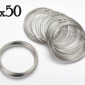 May include: A pack of 50 silver wire rings, ideal for crafting jewellery or other DIY projects.