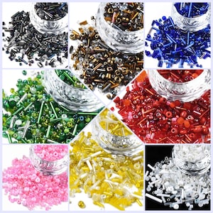 May include: Assortment of colourful glass seed beads and bugle beads in various colours, including black, green, red, gold, white, and blue. The beads are displayed in small glass bowls.