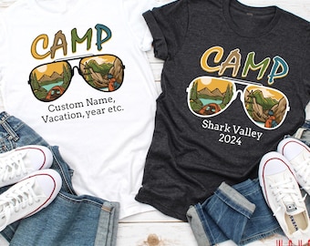 May include: Two t-shirts with a graphic of sunglasses with a camping scene reflected in the lenses. The white t-shirt says "CAMP" and "Custom Name, Vacation, year etc." The gray t-shirt says "CAMP" and "Shark Valley 2024".