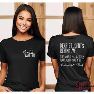 May include: Black t-shirt with white text that reads "You Matter" on the front and "Dear Students Behind Me, The World Is A Better Place With You In It. Remember That" on the back.