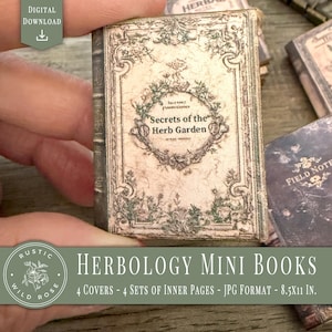 May include: A miniature book titled "Secrets of the Herb Garden" with a distressed, vintage aesthetic. The cover features floral illustrations and the text is surrounded by a decorative wreath. The image also shows other miniature books.