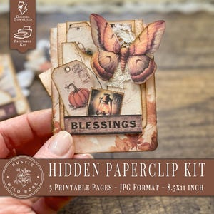 May include: A vintage-style paperclip kit featuring a butterfly and pumpkin design. The kit includes printable pages with a rustic aesthetic. The word "BLESSINGS" is displayed on a wooden sign. The kit is 21.6 x 27.9 cm.