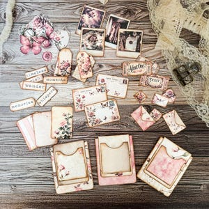 Digital printable dusty rose hidden paperclip kit featuring vintage-inspired designs for junk journals, scrapbooking, and paper crafts. Includes floral and shabby chic patterns in soft pink tones, ideal for creating hidden paperclip embellishments, tags, and decorative journal accents. High-resolution JPEG and PDF files for easy printing and cutting. Perfect for romantic, vintage, and shabby chic crafting themes.