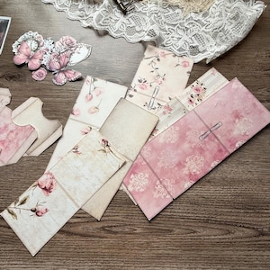 Digital printable dusty rose hidden paperclip kit featuring vintage-inspired designs for junk journals, scrapbooking, and paper crafts. Includes floral and shabby chic patterns in soft pink tones, ideal for creating hidden paperclip embellishments, tags, and decorative journal accents. High-resolution JPEG and PDF files for easy printing and cutting. Perfect for romantic, vintage, and shabby chic crafting themes.
