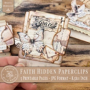 May include: A stack of vintage-style paperclips with a butterfly accent and the word "Grace" on top. The paperclips are adorned with aged paper and lace, with the text "Faith Hidden Paperclips" and "8.5x11 inch" visible. The overall theme is rustic and faith-based.