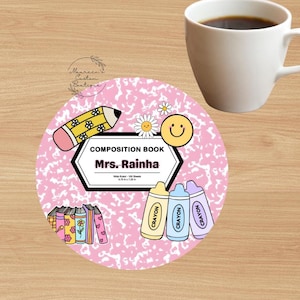 May include: Pink and white composition book cover with a pencil, crayons, and a smiley face. The text on the cover reads "Composition Book Mrs. Rainha".