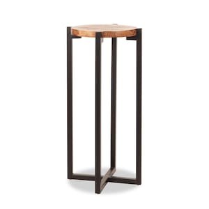 May include: A small, round wooden side table with a natural wood grain top. The table has a black metal frame with a cross-shaped base and measures approximately 24 inches tall.