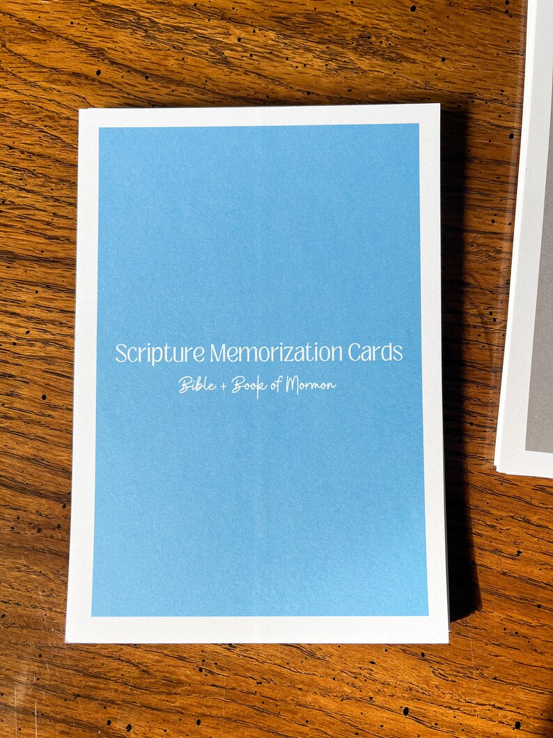 May include: A blue card with white text that reads "Scripture Memorization Cards Bible + Book of Mormon".