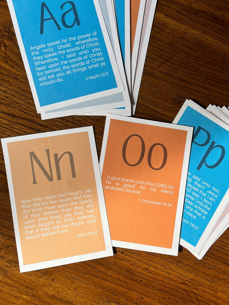 May include: Four colourful cards with large letters and scripture verses. The cards are orange, blue, and pink. The letters are N, O, P, and A. The verses are from the Book of Mormon, the Bible, and the Book of Alma.