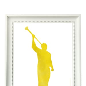 May include: A yellow silhouette of an angel blowing a trumpet. The angel is depicted in a watercolor style with a speckled texture.