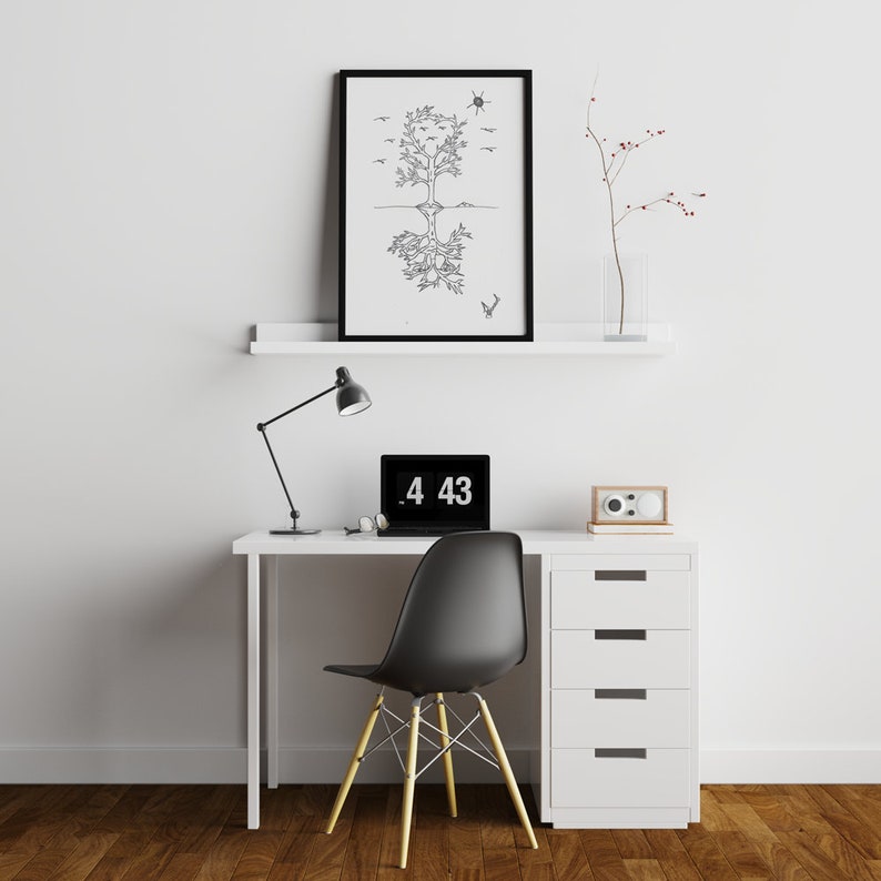 May include: A white desk with a black lamp, a laptop with the time 4:43 displayed, a white chair, and a white cabinet with four drawers. A black framed print of a tree with birds and a sun above it hangs on the wall above the desk. A small white shelf with a vase of red berries sits above the desk.
