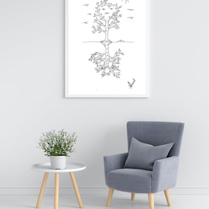 May include: A black and white line drawing of a tree with roots and birds flying above. The drawing is framed and hanging on a white wall above a gray armchair and a white side table with a potted plant.