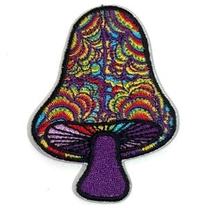 May include: A colorful mushroom patch with a psychedelic design. The patch features a purple stem and a cap filled with swirling patterns in shades of red, yellow, blue, and green, outlined with black stitching.