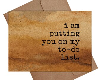 May include: A greeting card with a watercolor-style background in shades of brown and tan, with the text "i am putting you on my to-do list." The card is placed on top of a brown envelope.