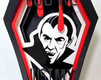 May include: A black and red papercraft coffin with a vampire illustration and the text "You're Just My Type".